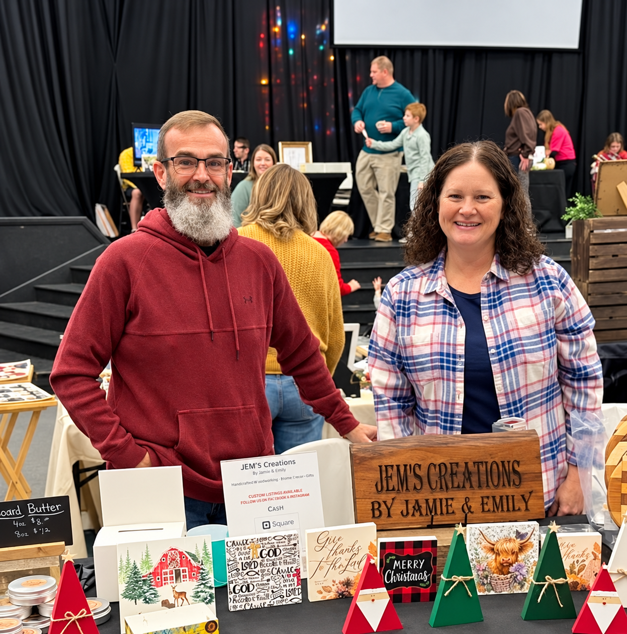 Jamie and Emily behind their display of handmade pieces at a show
