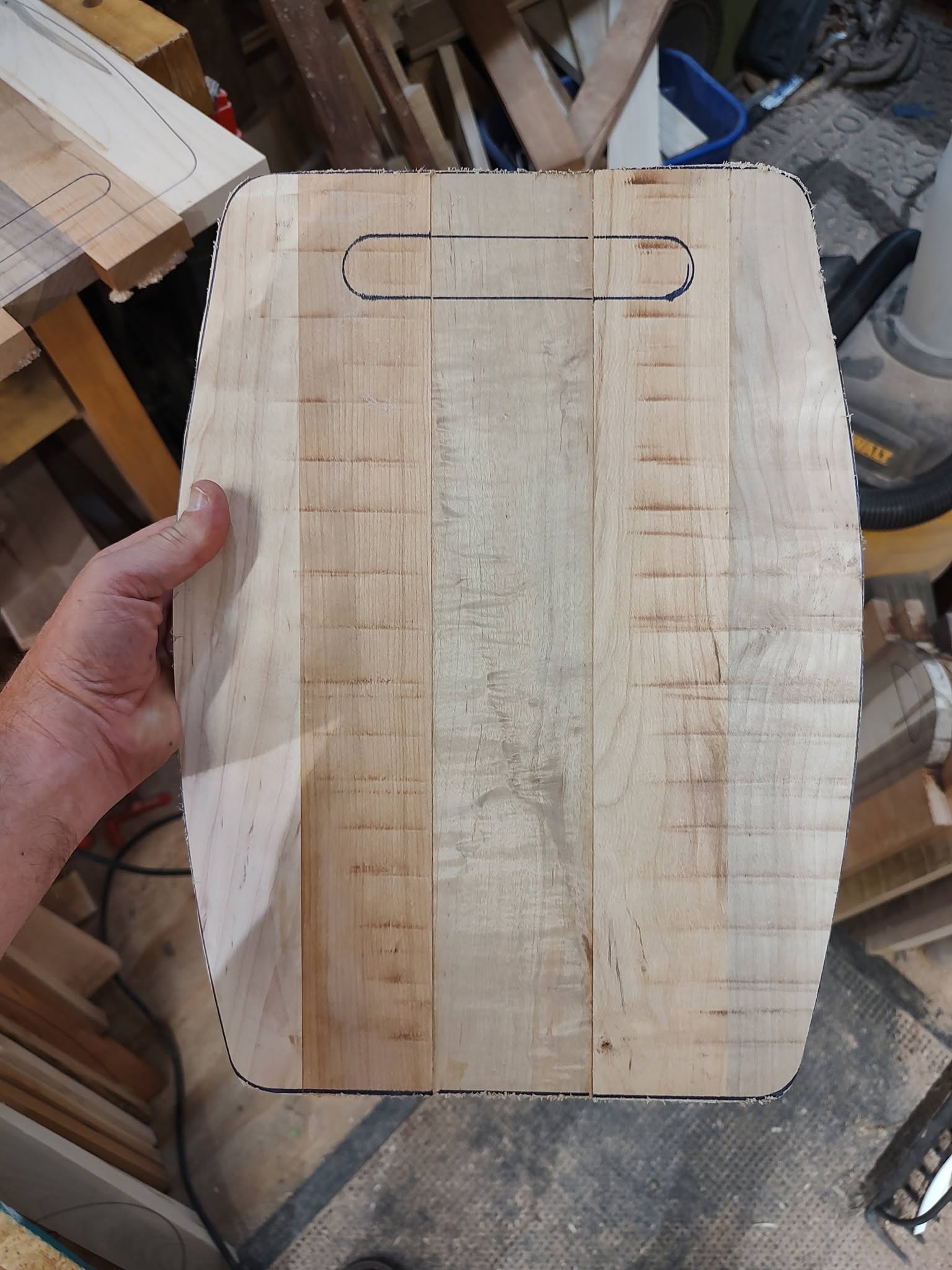 A handmade board with its rounded outline and handle marked for shaping